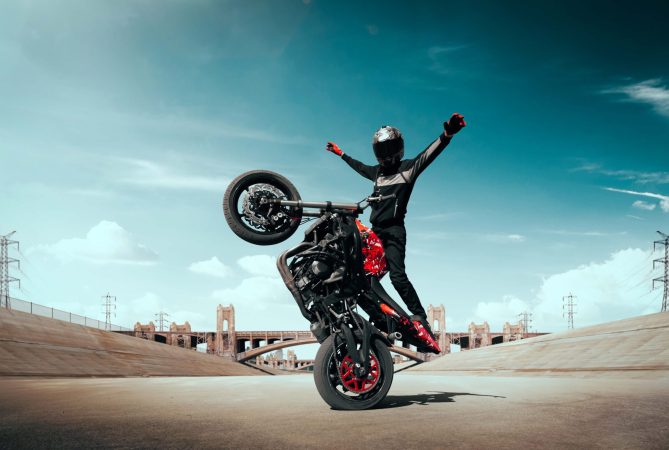 moto-rider-making-stunt-his-motorbike-biker-doing-difficult-dangerous-stunt moto-rider-making-stunt-his-motorbike-biker-doing-difficult-dangerous-stunt